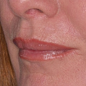Profile of a woman against a blue background.