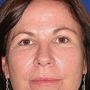 Middle-aged woman with brown hair and eyes.