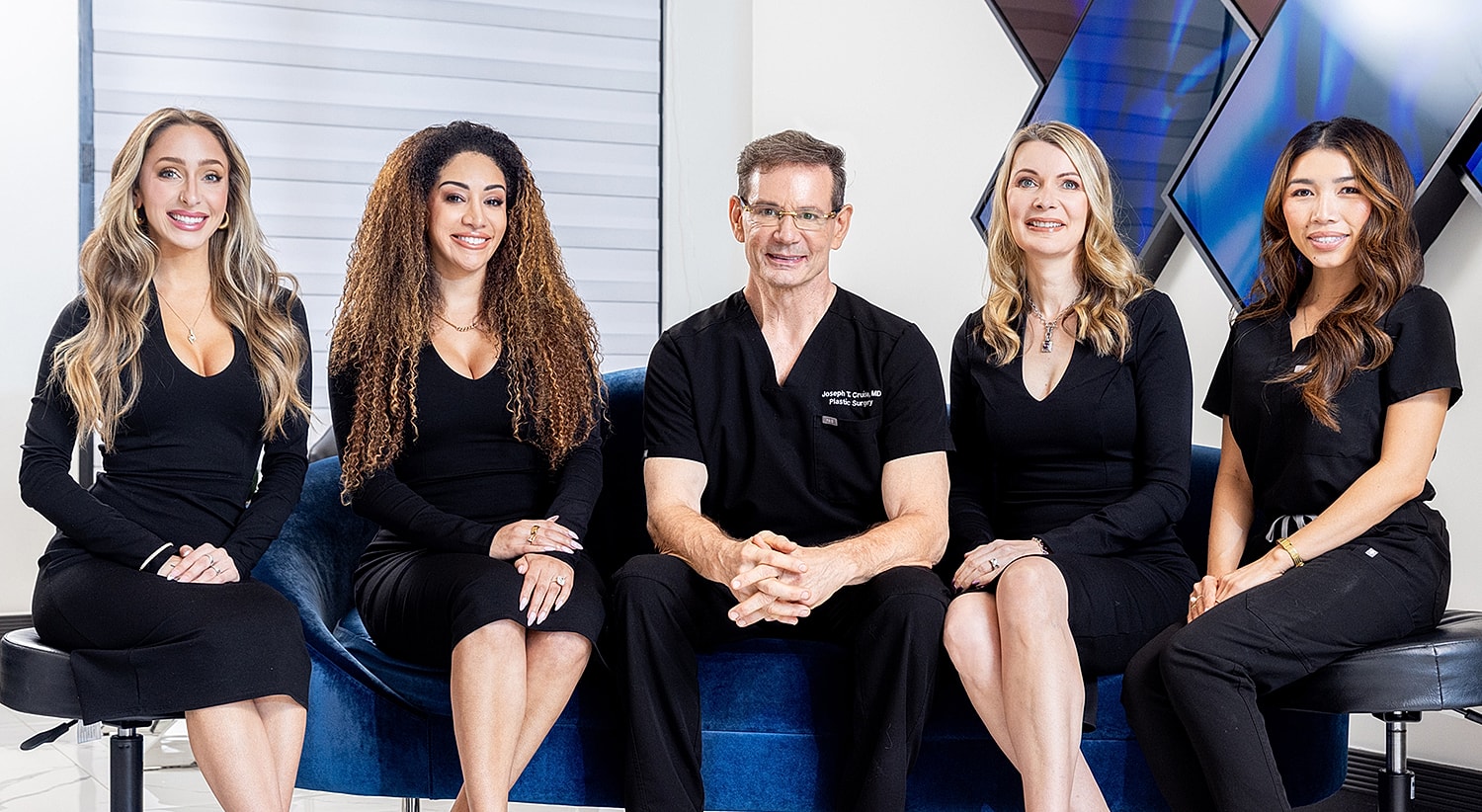 Professional team posing in clinic setting.