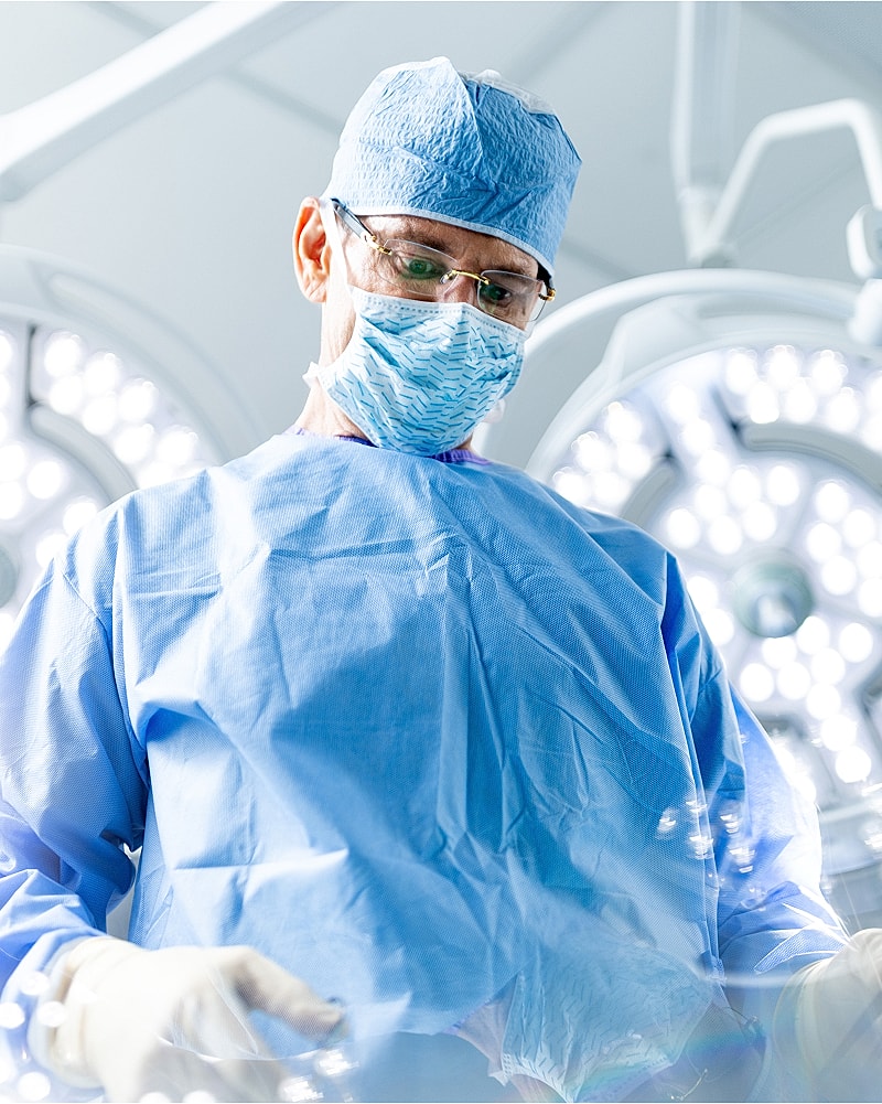 Surgeon focused in a sterile operating room.