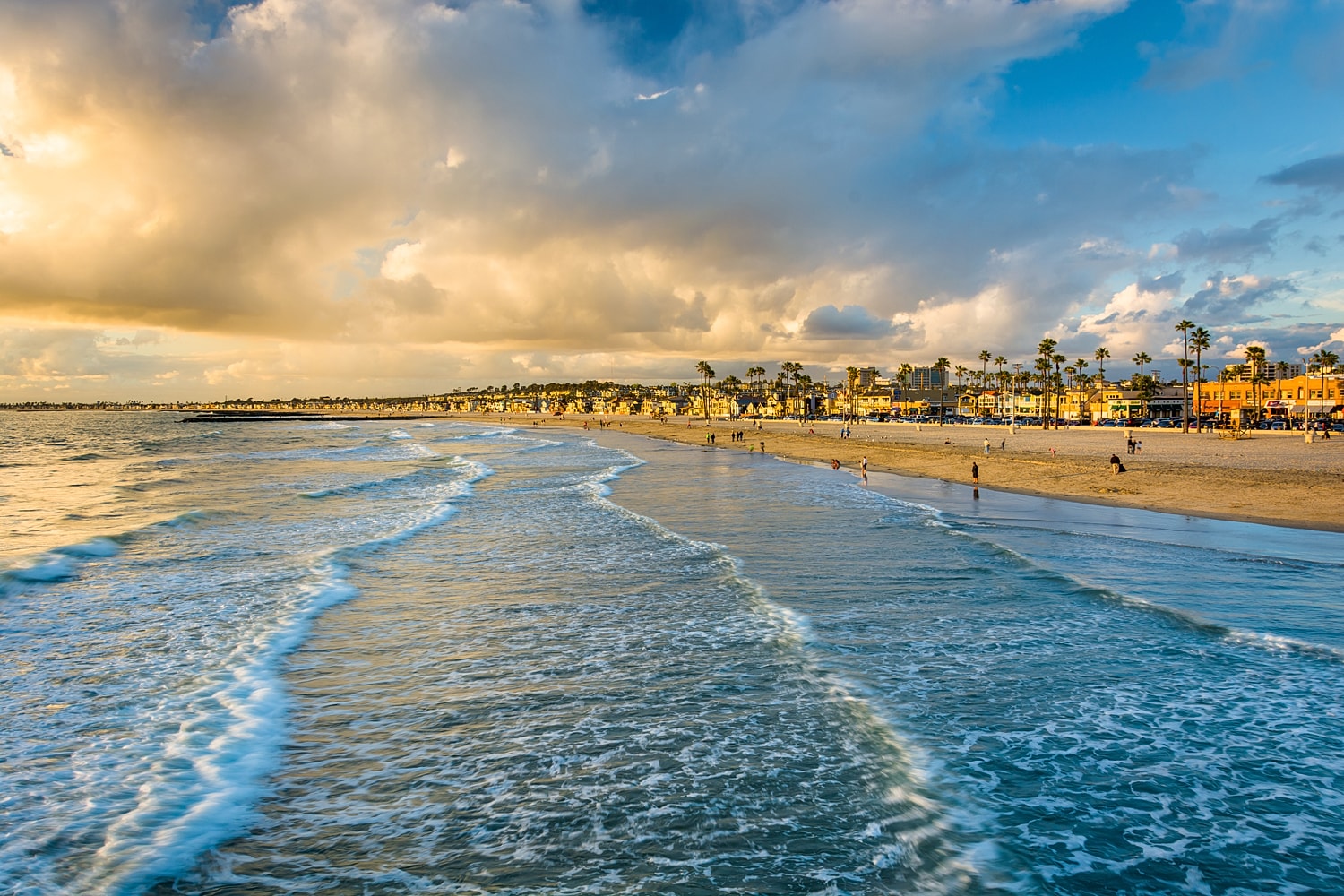 Beautiful beach scene at sunset with people.