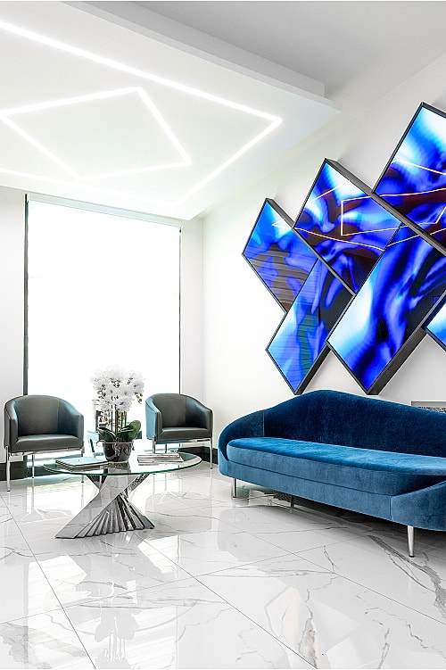 Orange County plastic surgery reception with blue decor and artwork.