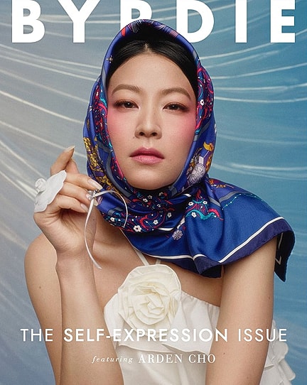 Magazine cover featuring model in vibrant scarf.
