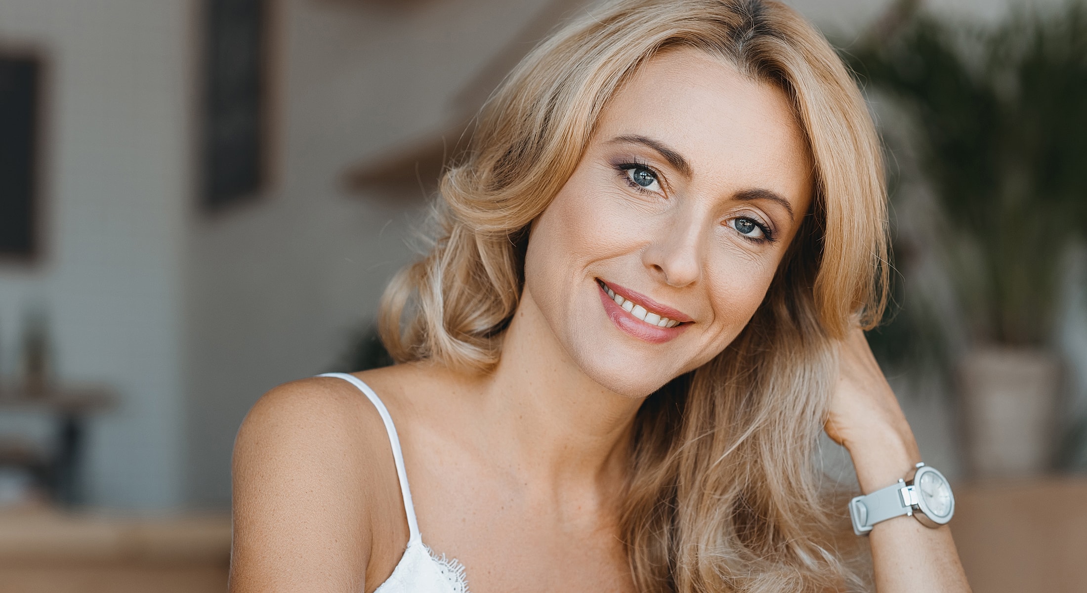 Orange County fat transfer model with blonde hair in casual setting.