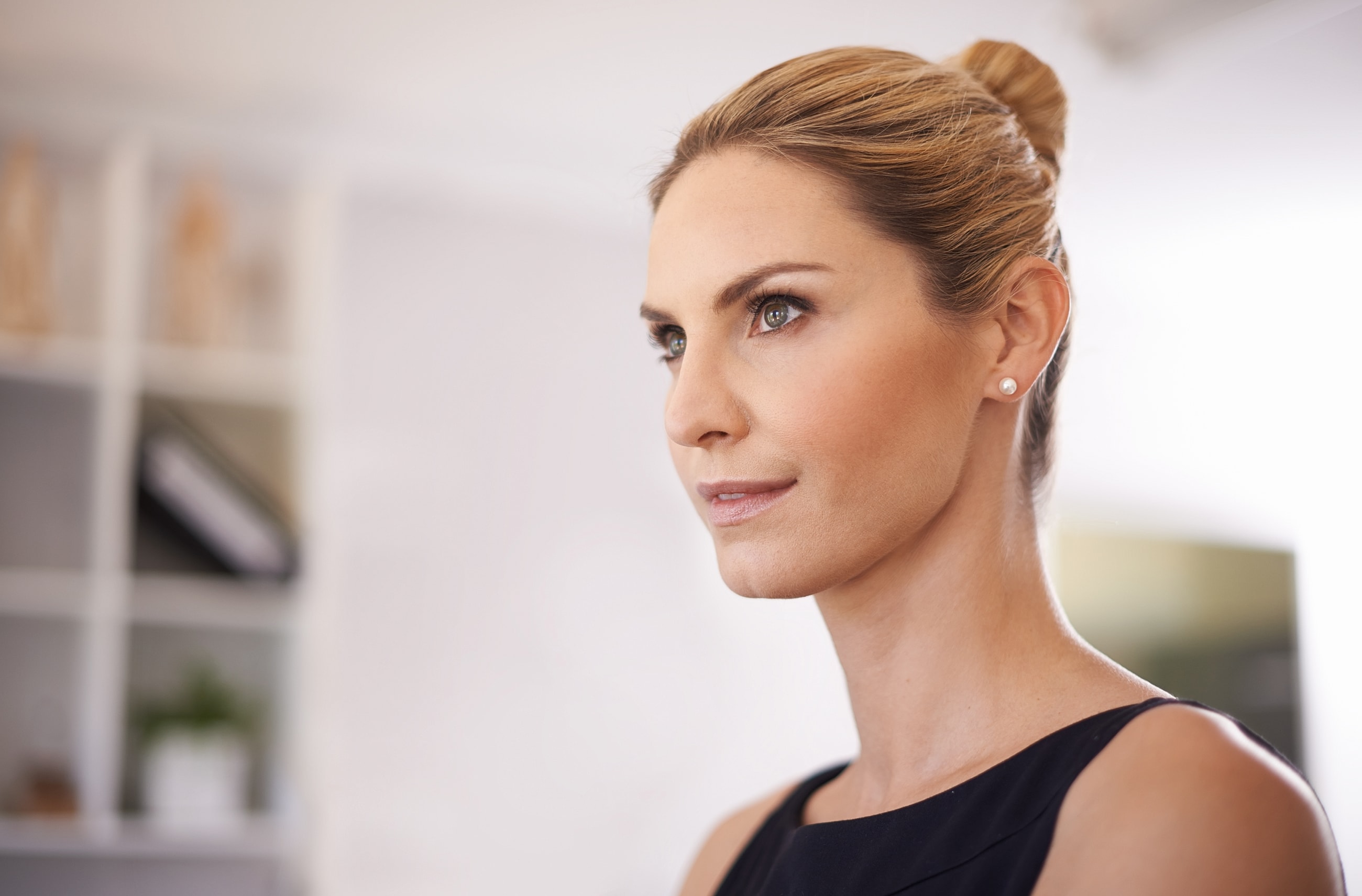 Orange County Lower Face Rejuvenation model with blonde hair in casual setting.